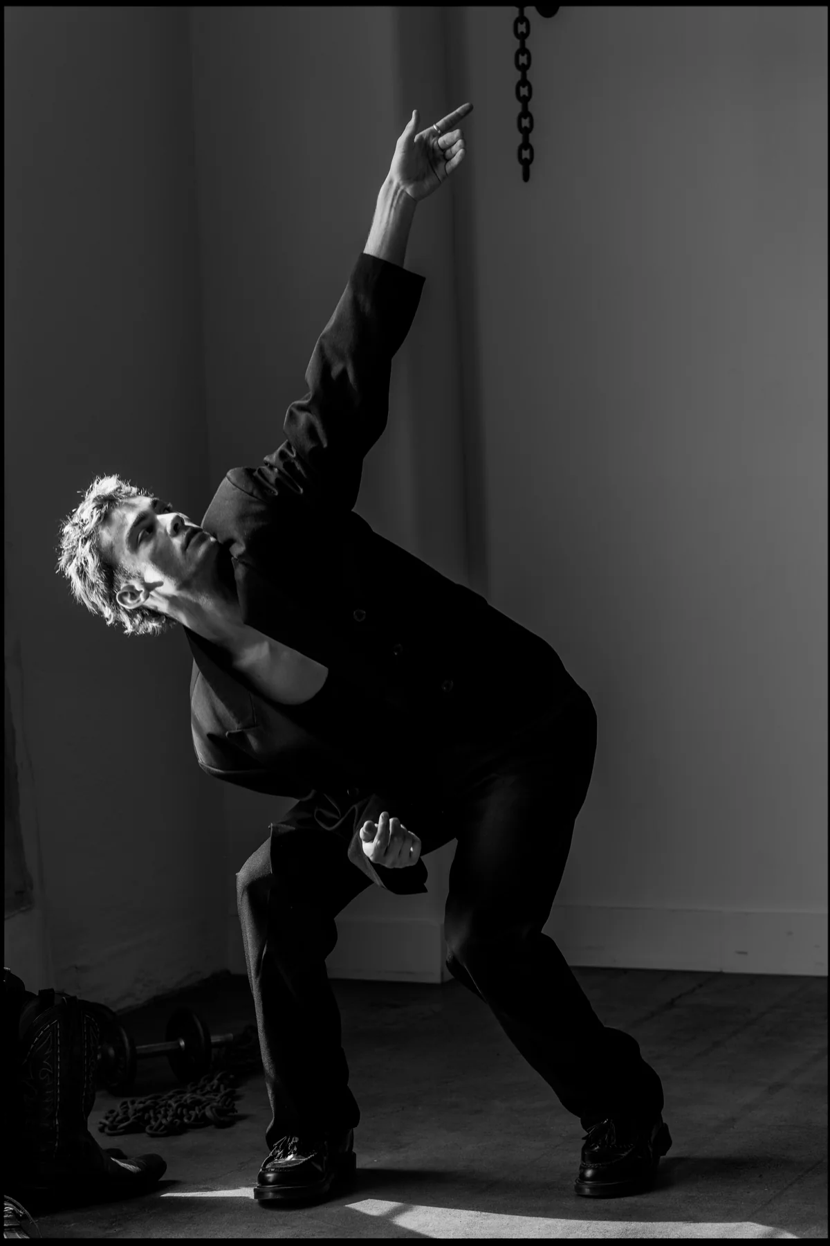 Jeffrey reaching upward in a black-and-white movement portrait