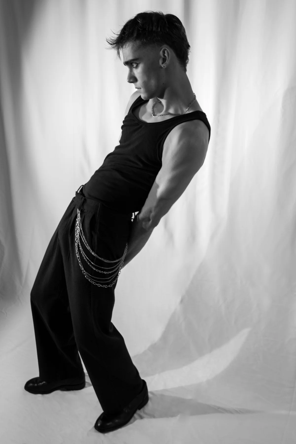 Jeffrey leaning into a sculptural black-and-white pose