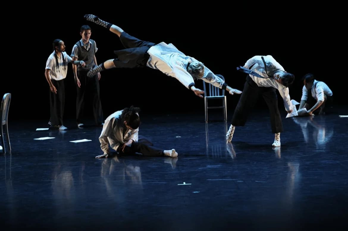 A sequence of acrobatic partnering on stage