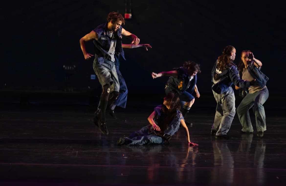 Jeffrey performing with an ensemble under stage lights