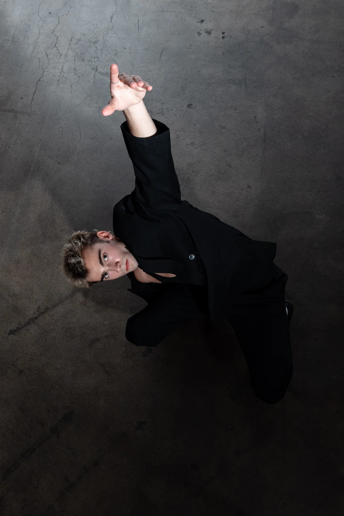 Jeffrey reclining on the studio floor in black