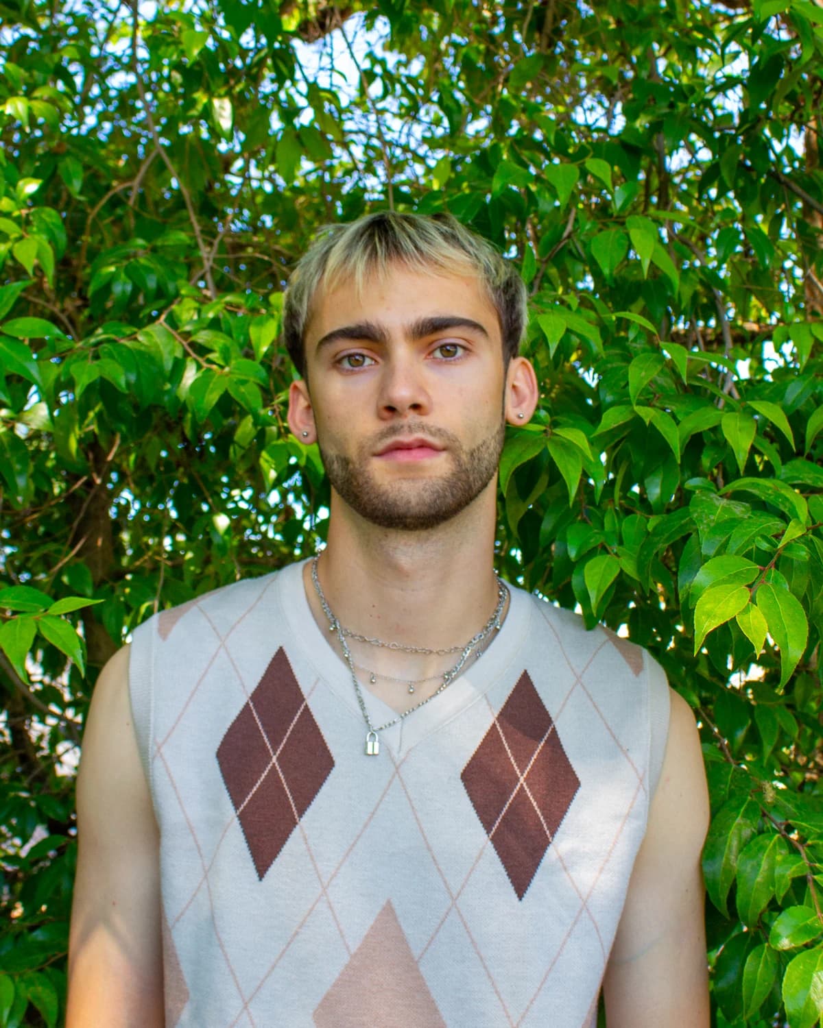 Jeffrey standing in front of vivid green foliage